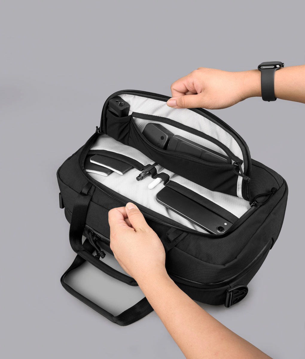 Bravo Brief 14 opened from above with compact tech, stationery and cards organized inside