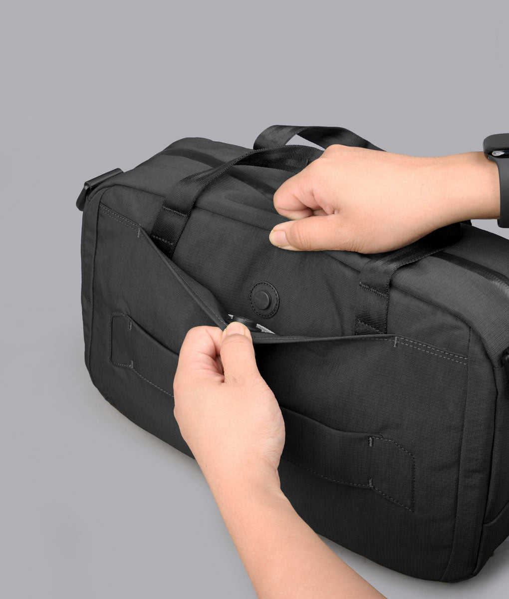 Hidden rear pocket being opened on the black Bravo Brief 14
