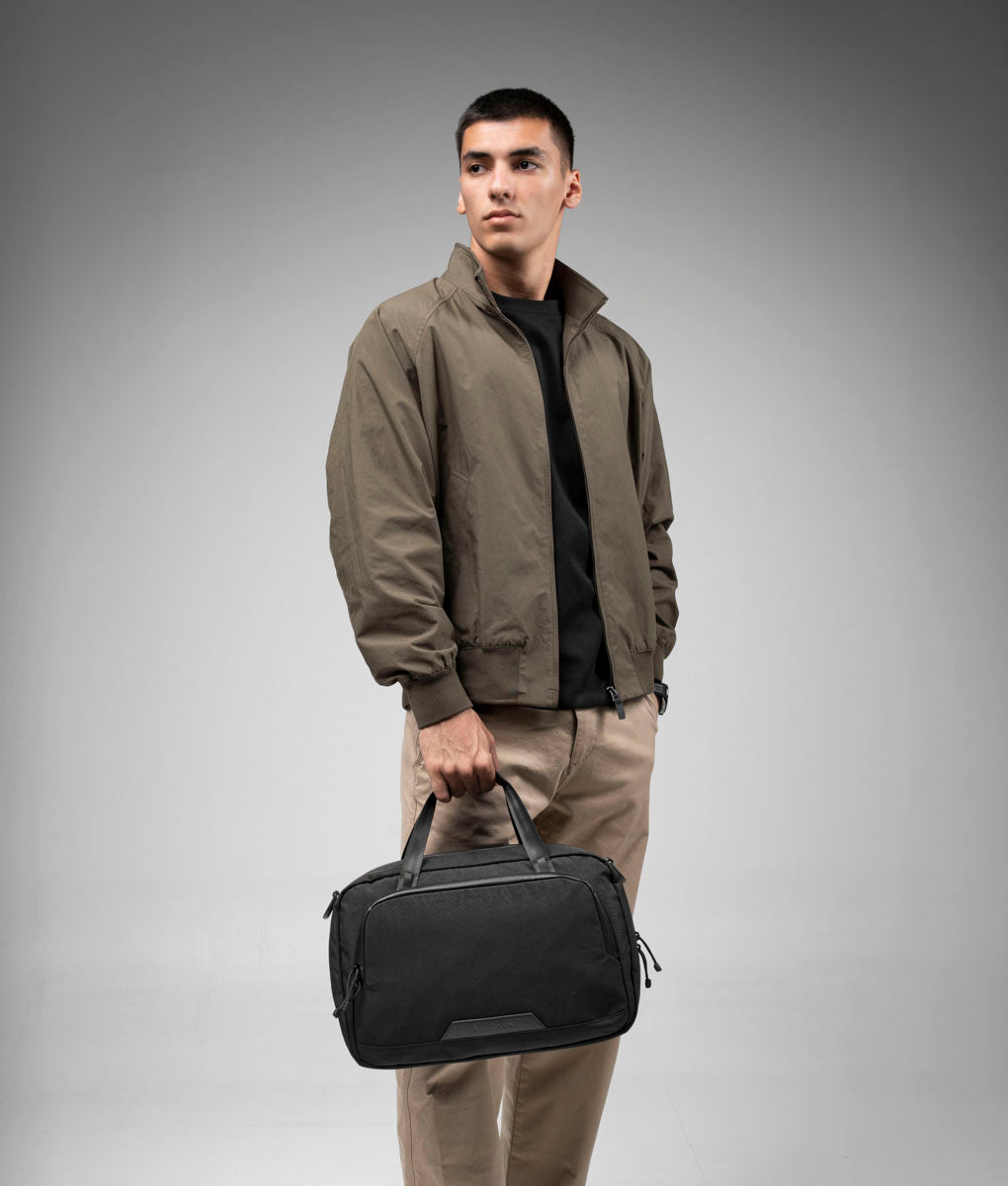Black Bravo Brief 14 carried over the shoulder with its padded strap