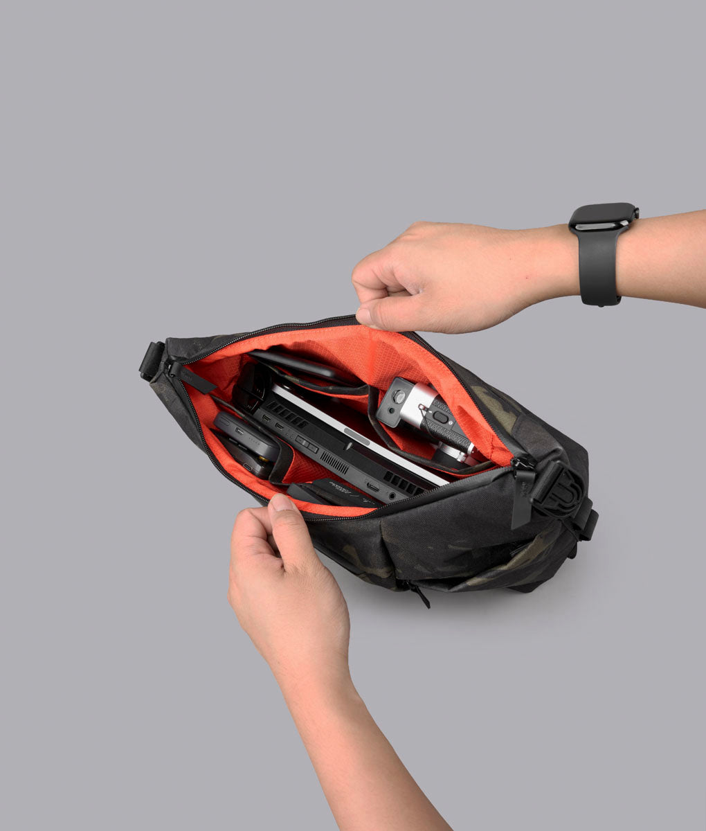 Open ClogTwo Edition satchel showing the orange X-Grid interior with tech packed inside