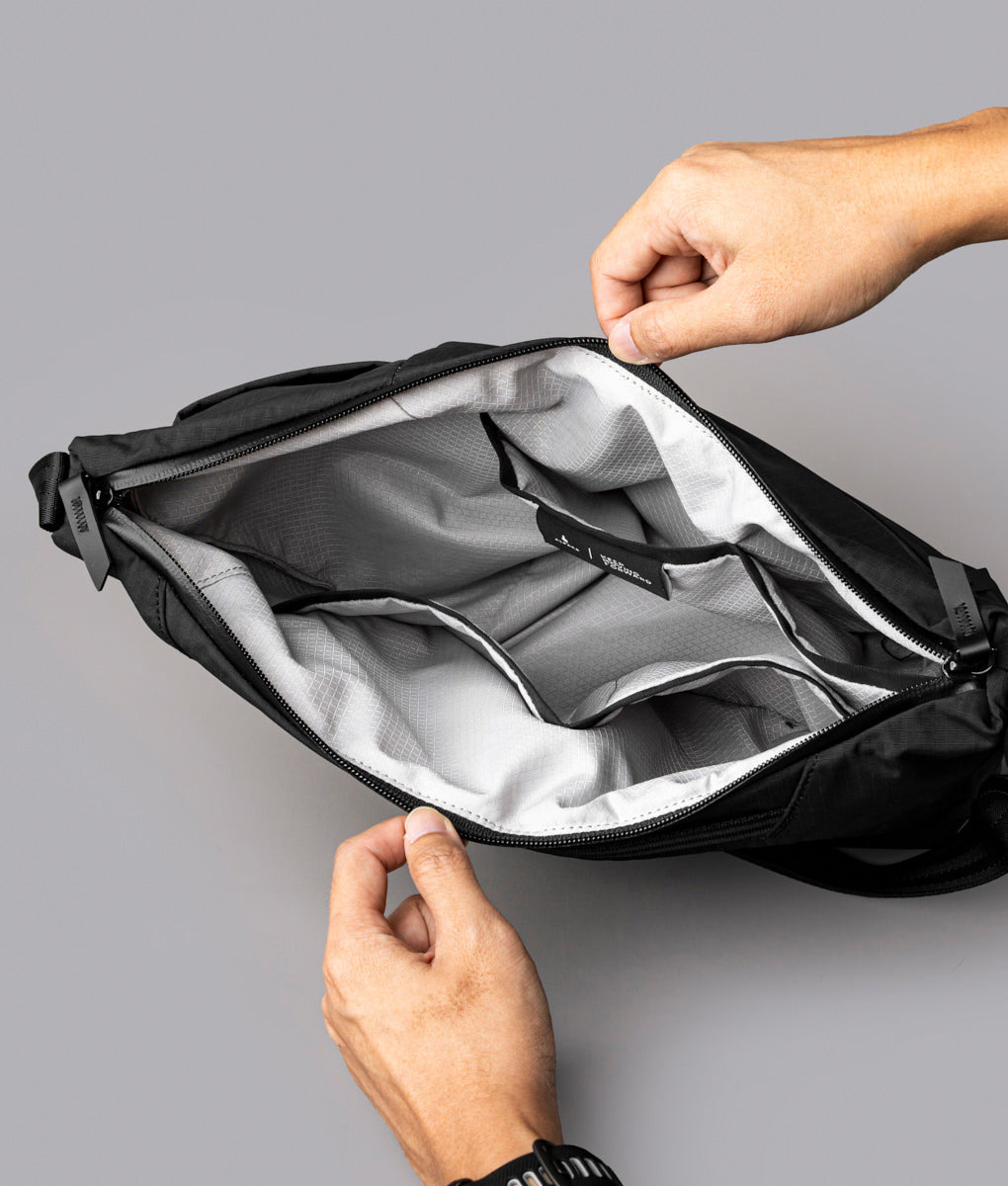 Open Flow Satchel 4L showing its internal compartments and light-coloured lining
