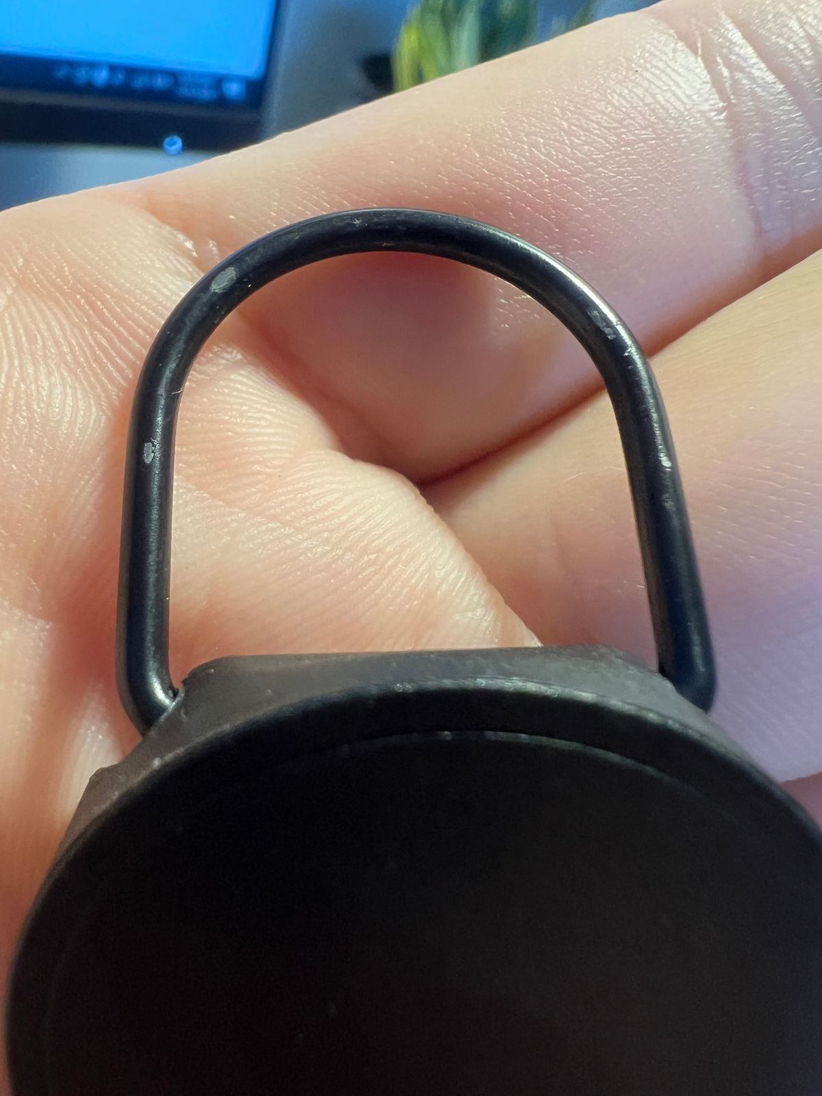 Customer close-up of key-tether finish wear, view three